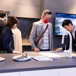 showroom Yoshimoto tại Hà Nội với khách hàng đang xem chậu rửa chén CRYSTAL SURFACE thực tế